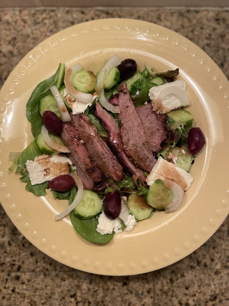 Roasted lamb over greens with feta, onions, cucumbers, and olives. Drizzled with balsamic vinegar.